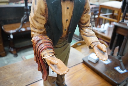 A painted composition dumb waiter in the form of an elderly butler, width 34cm, height 95cm